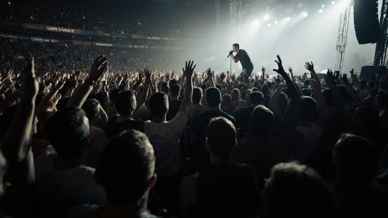 A crowd at a live concert, all faces lit by stage lights, no phones visible, fully immersed in the music.