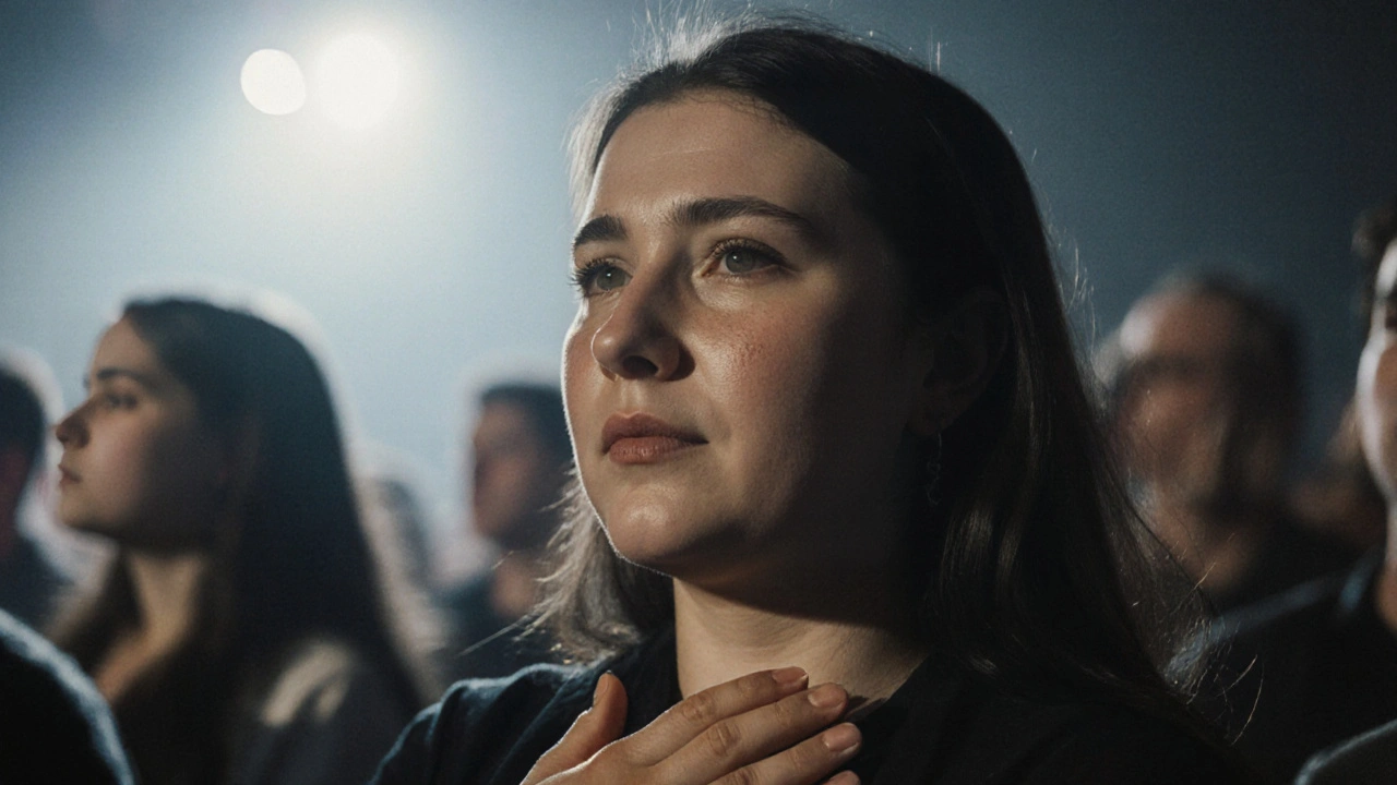 A fan crying softly during a ballad, hands over heart, completely present without a phone.